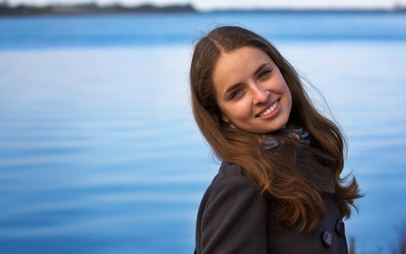 woman smiling by the water