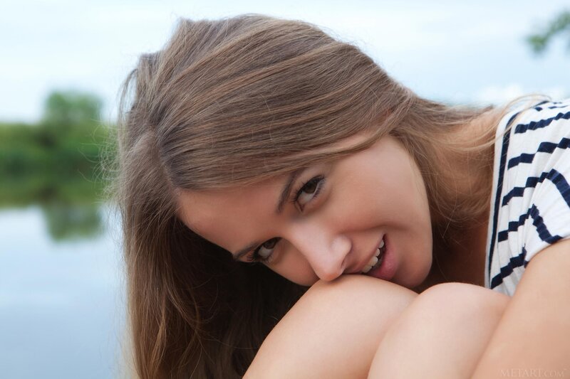 woman smiling by the water