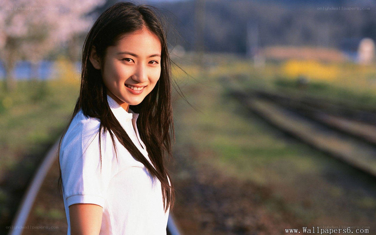woman smiling by train tracks