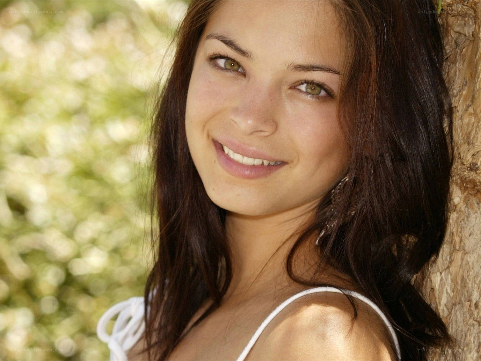 woman smiling by tree
