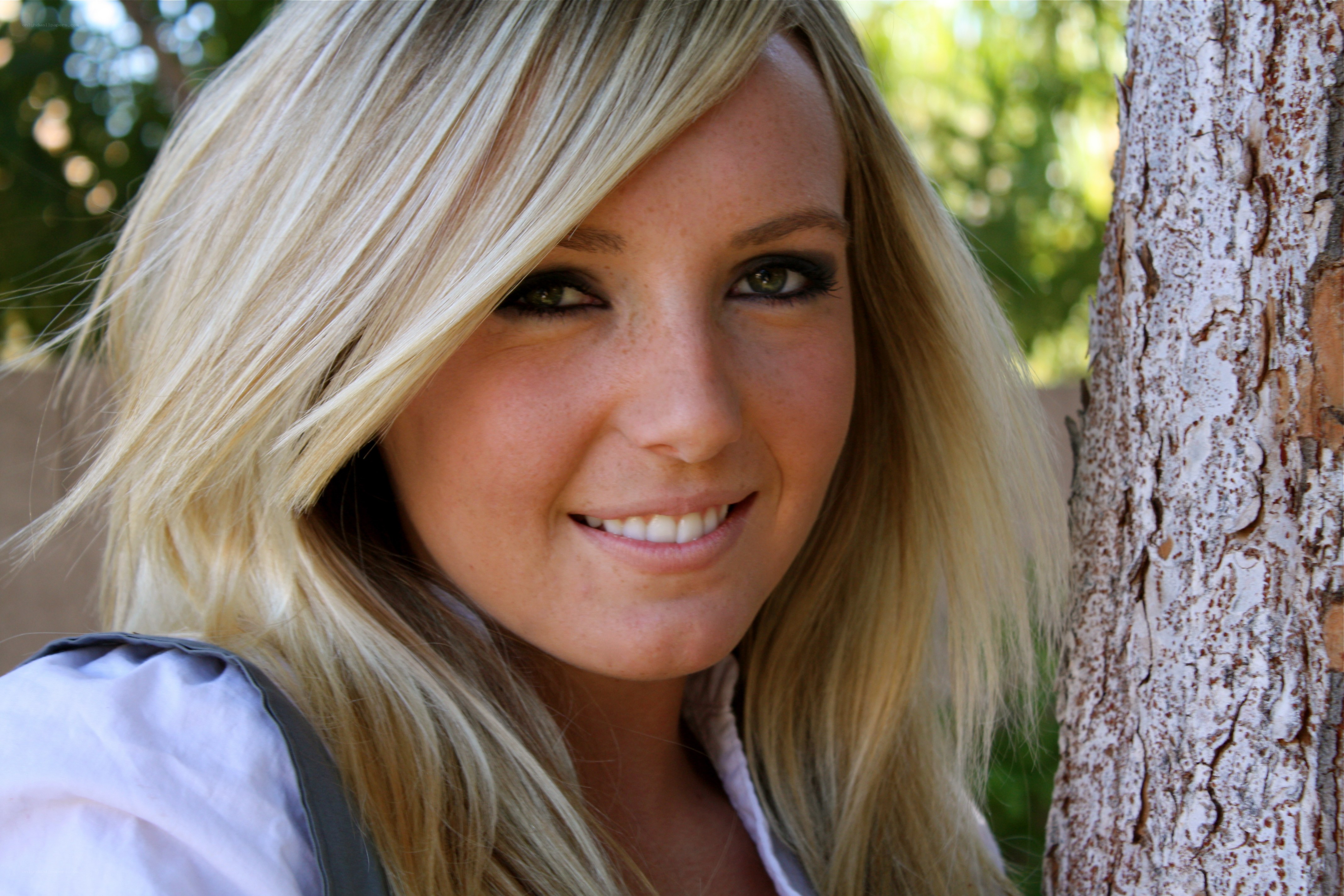 woman smiling by tree
