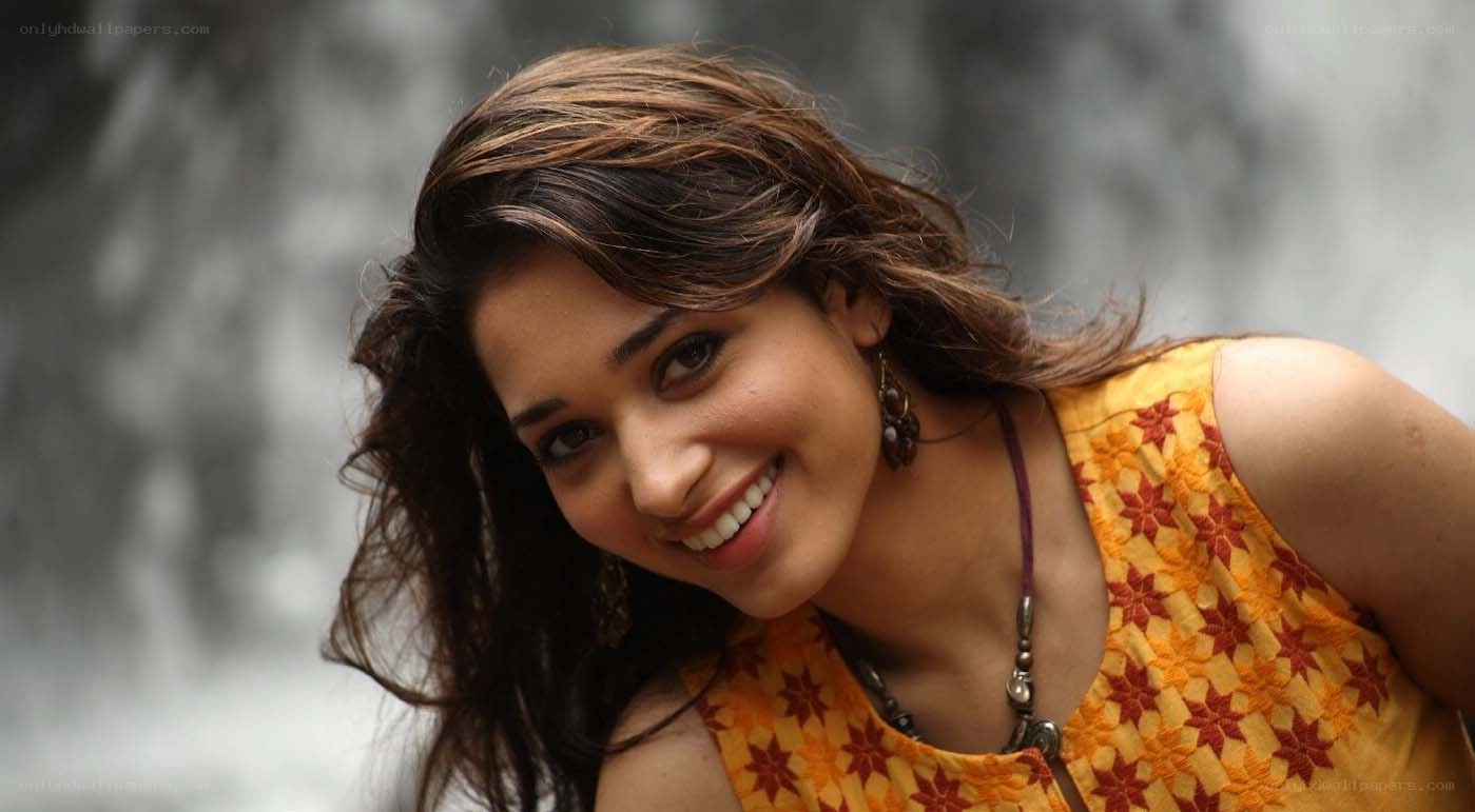 woman smiling by waterfall