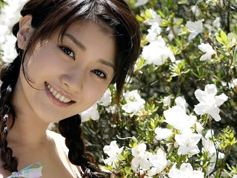 woman smiling by white flowers