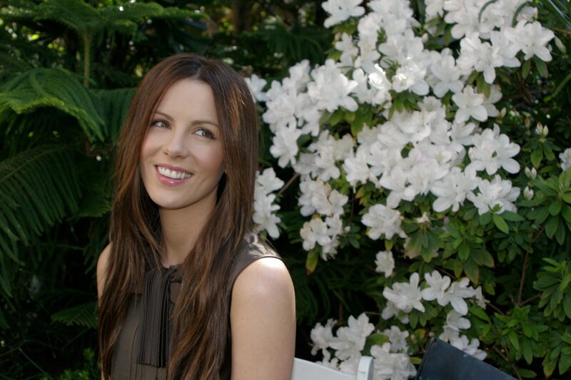 woman smiling by white flowers