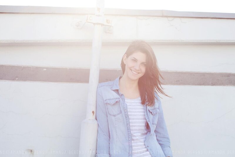 woman smiling by white wall