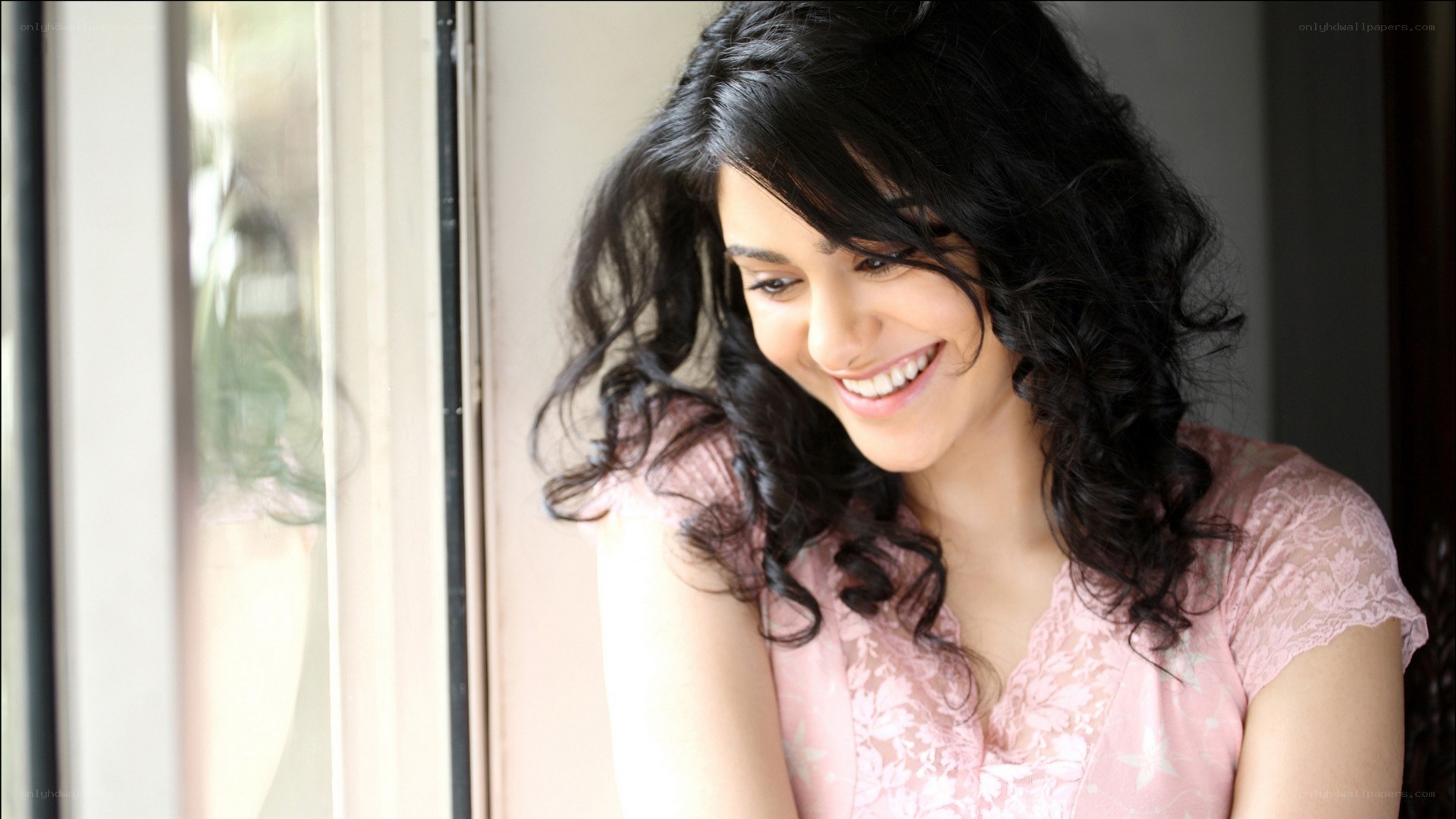 woman smiling by window