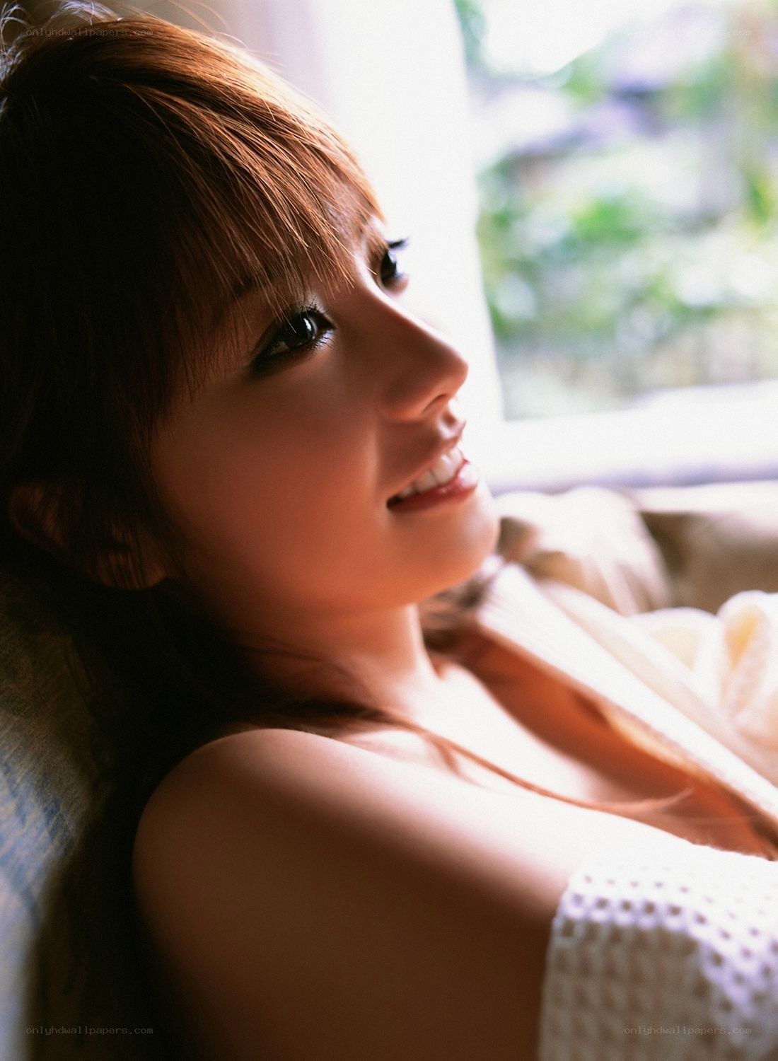 woman smiling by window
