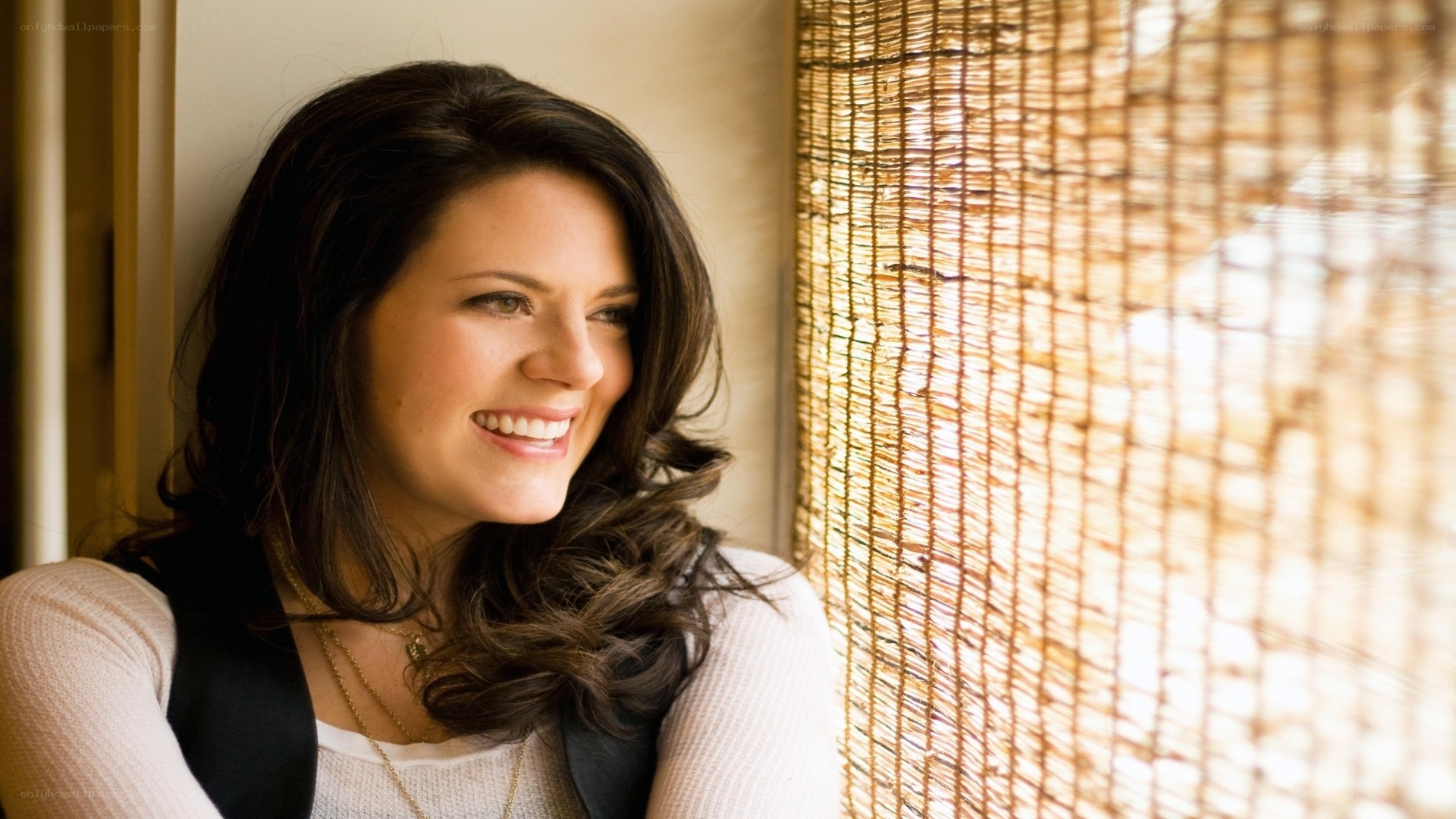 woman smiling by window