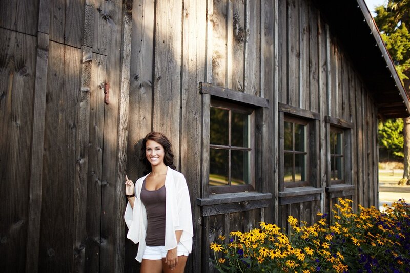 woman smiling by wooden barn