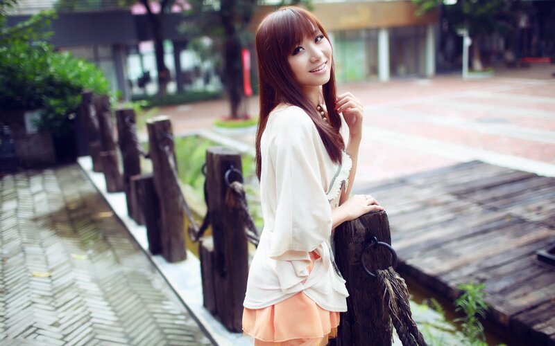 woman smiling by wooden railing