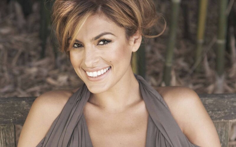 woman smiling in a brown dress
