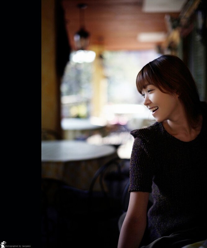 woman smiling in a cafe