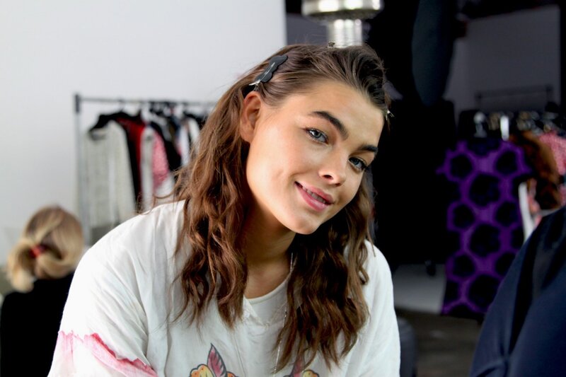 woman smiling in a clothing store