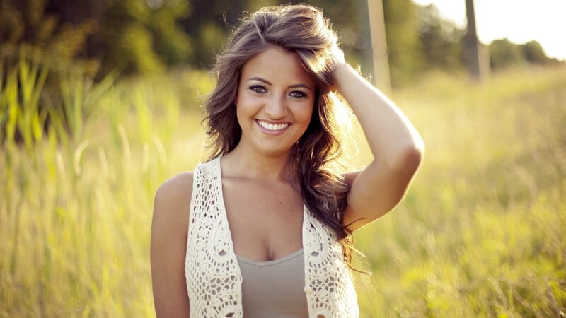 woman smiling in a field