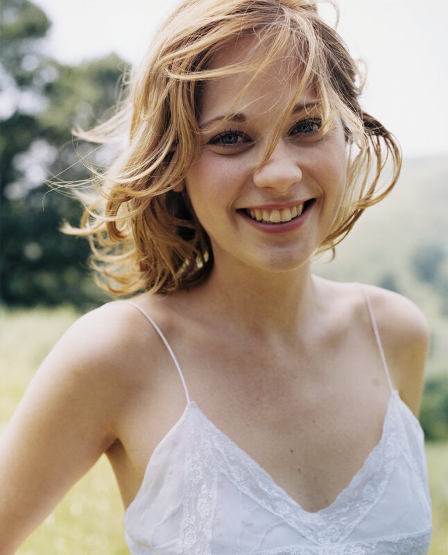 woman smiling in a field
