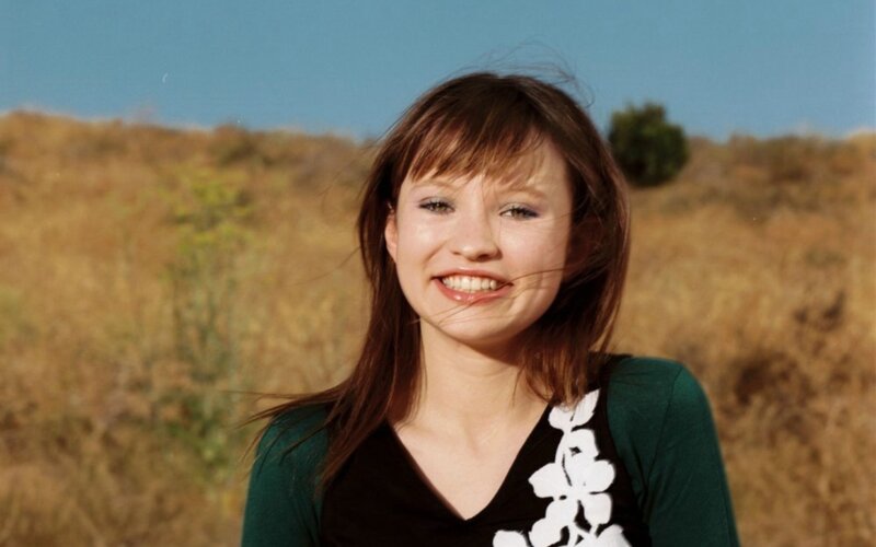 woman smiling in a field
