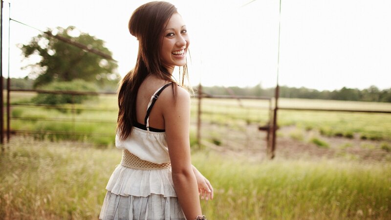 woman smiling in a field