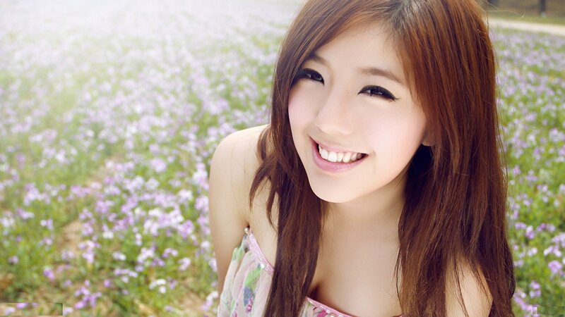 woman smiling in a flower field