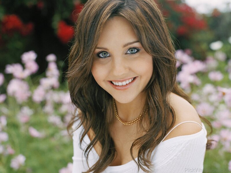 woman smiling in a flower garden