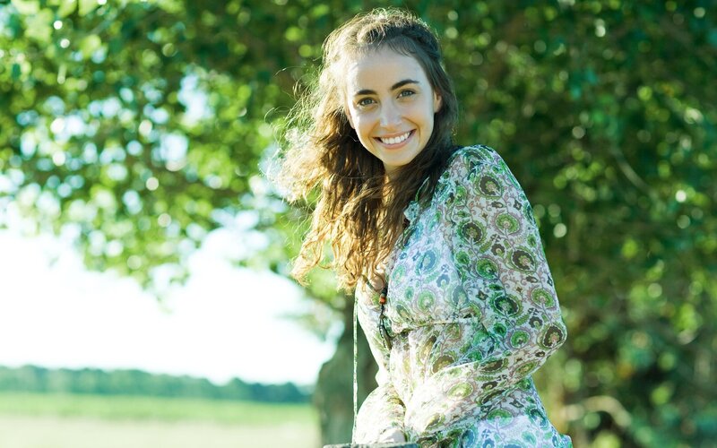 Woman smiling in a green field
