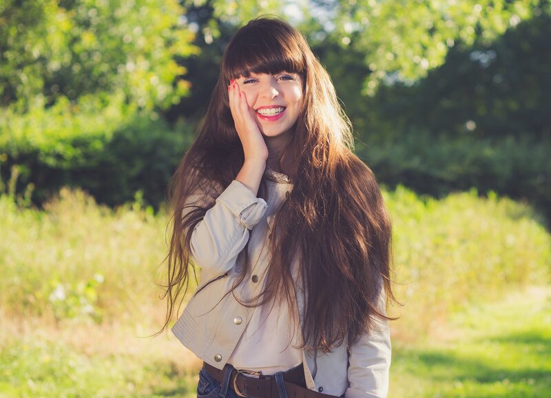 woman smiling in a park