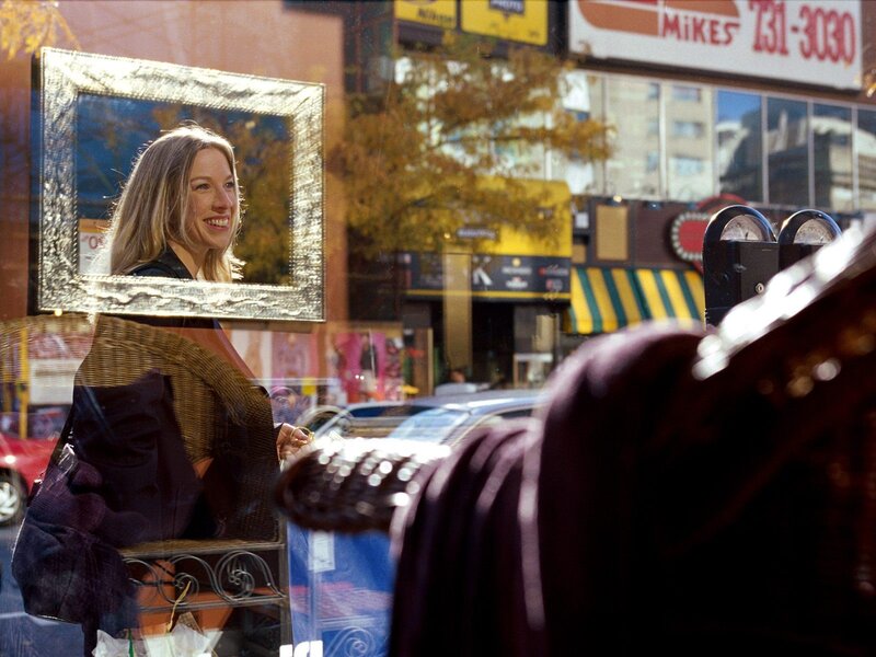 Woman smiling in a store window