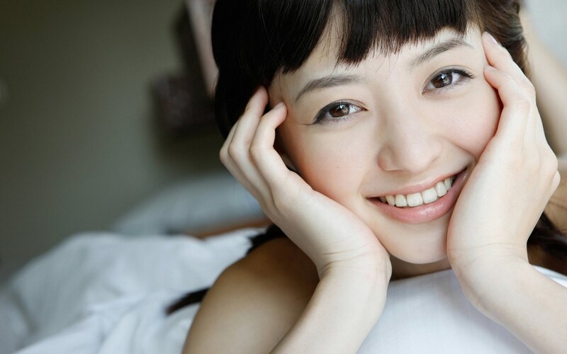 woman smiling in bed