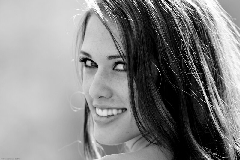woman smiling in black and white