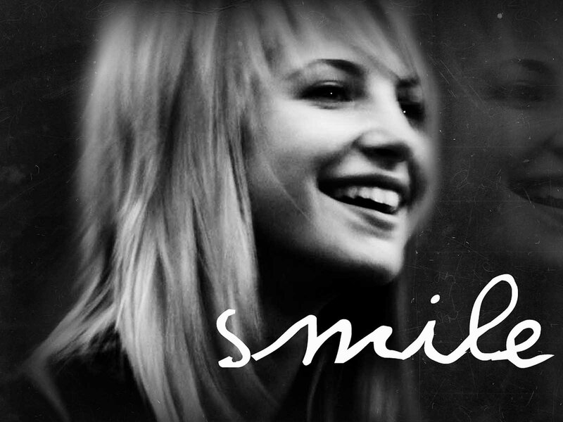 woman smiling in black and white