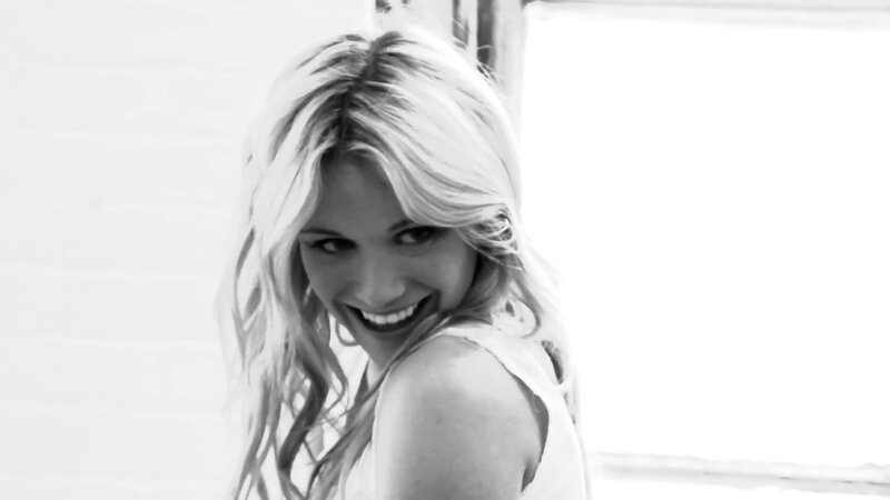 woman smiling in black and white