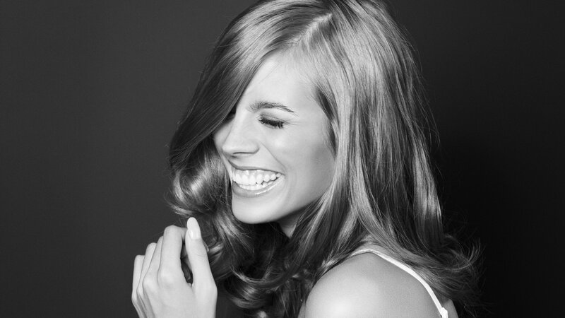 woman smiling in black and white