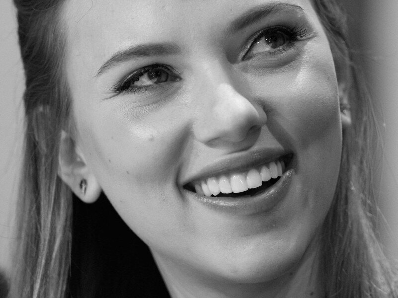 woman smiling in black and white