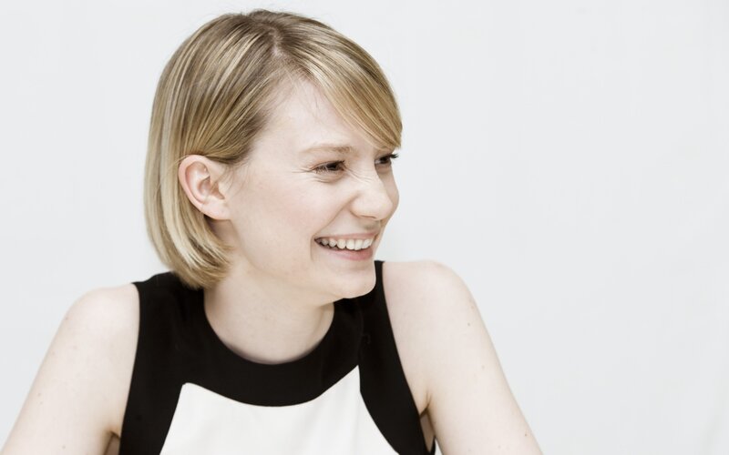 woman smiling in black and white dress
