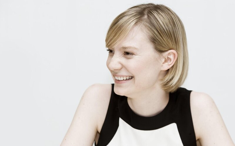 woman smiling in black and white dress