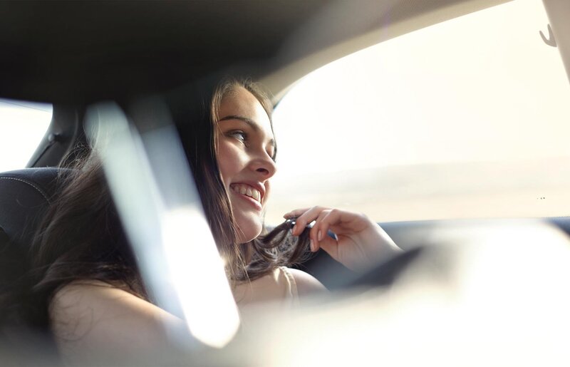 woman smiling in car