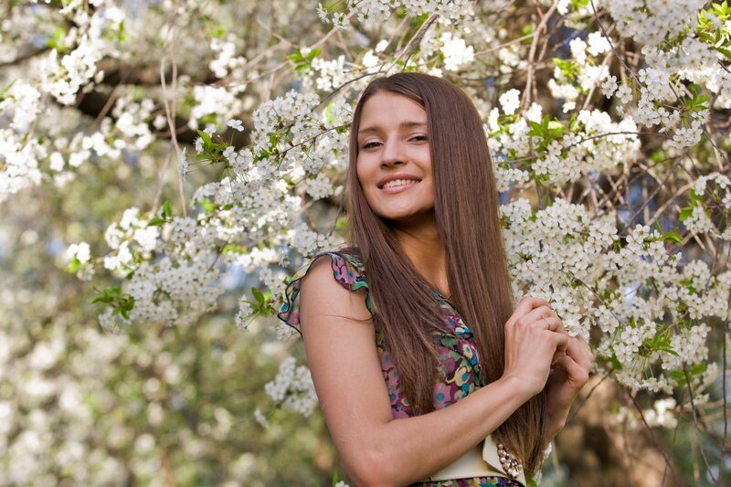 woman smiling in cherry blossoms