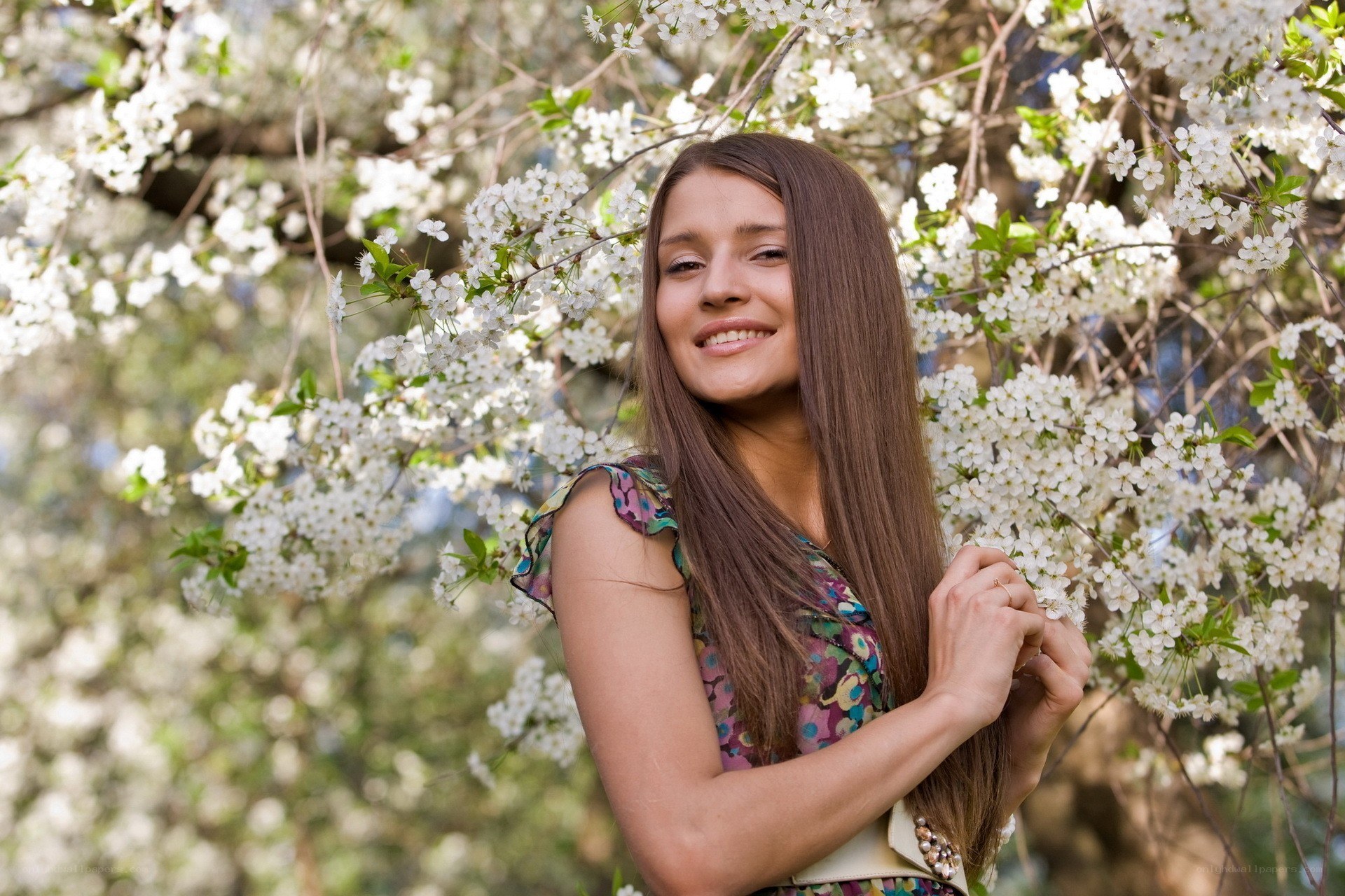 woman smiling in cherry blossoms