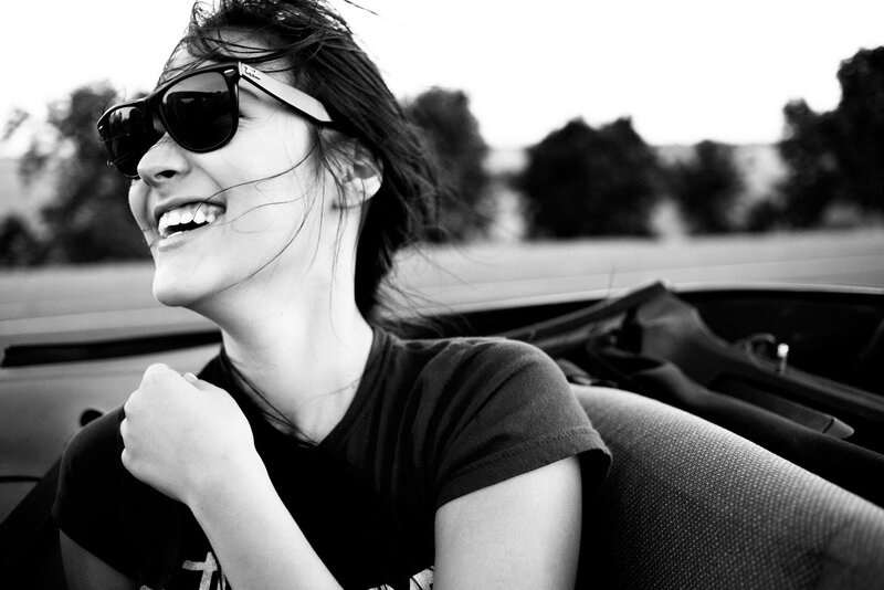 woman smiling in convertible