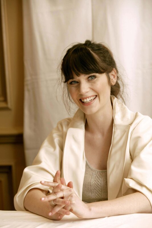 woman smiling in cream jacket