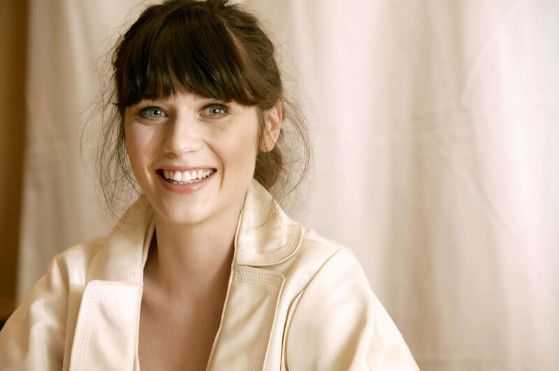 woman smiling in cream jacket