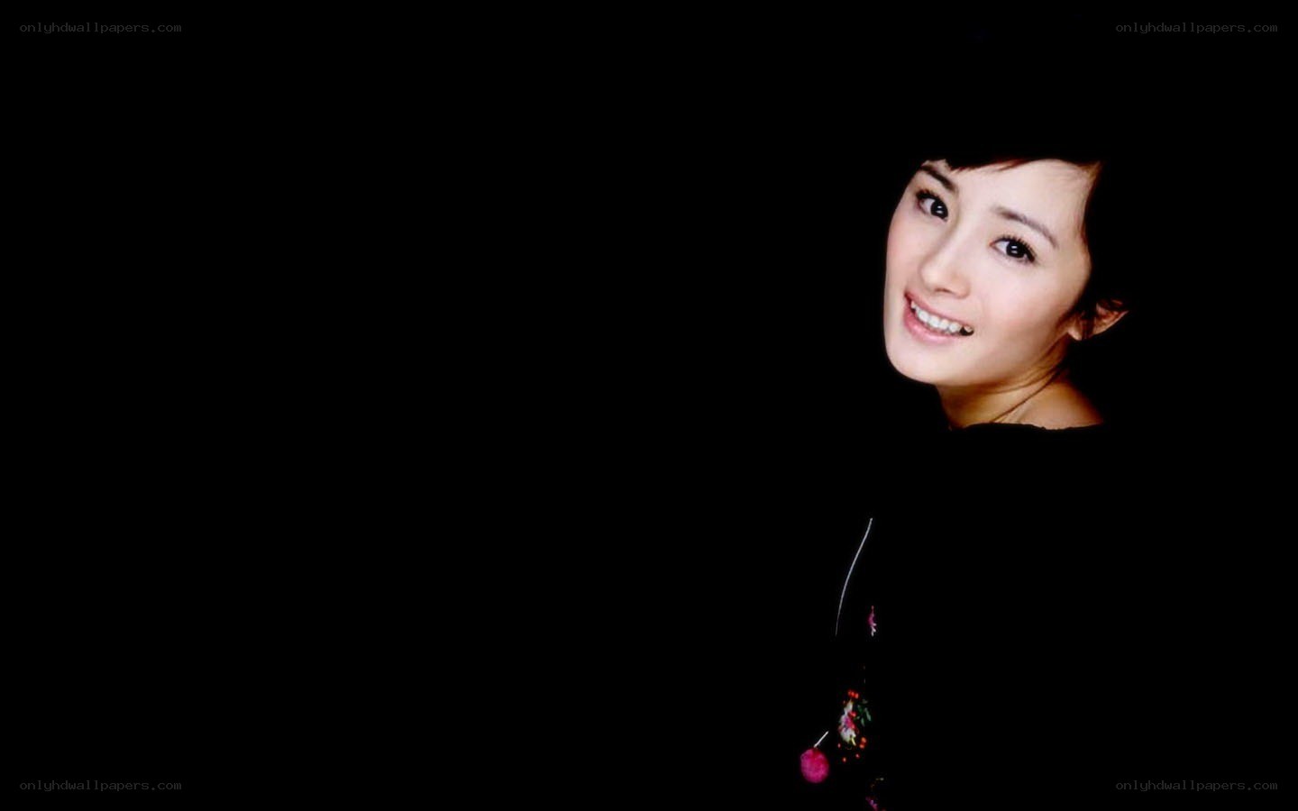 woman smiling in dark background