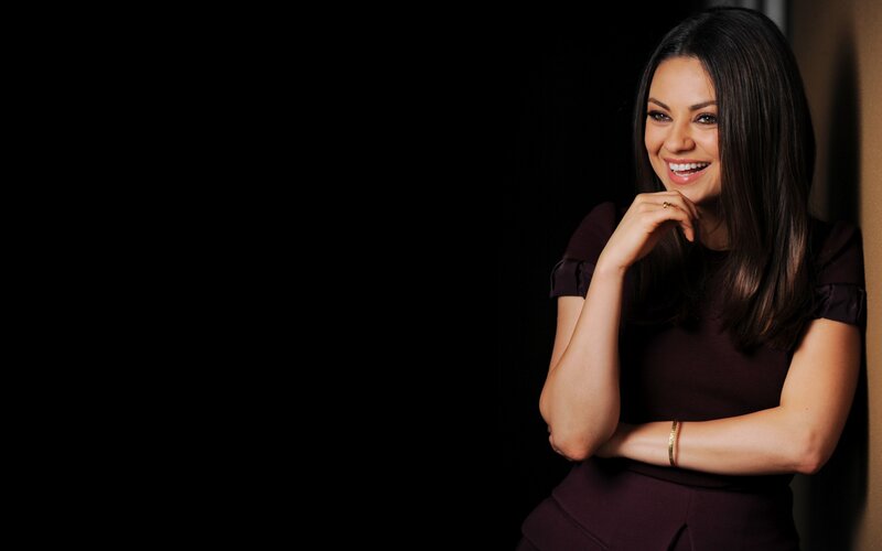 woman smiling in dark dress