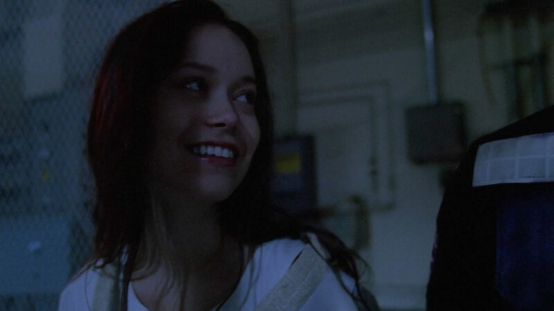 Woman Smiling in Dark Room