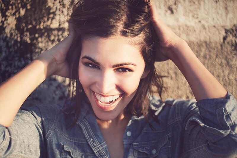 woman smiling in denim shirt