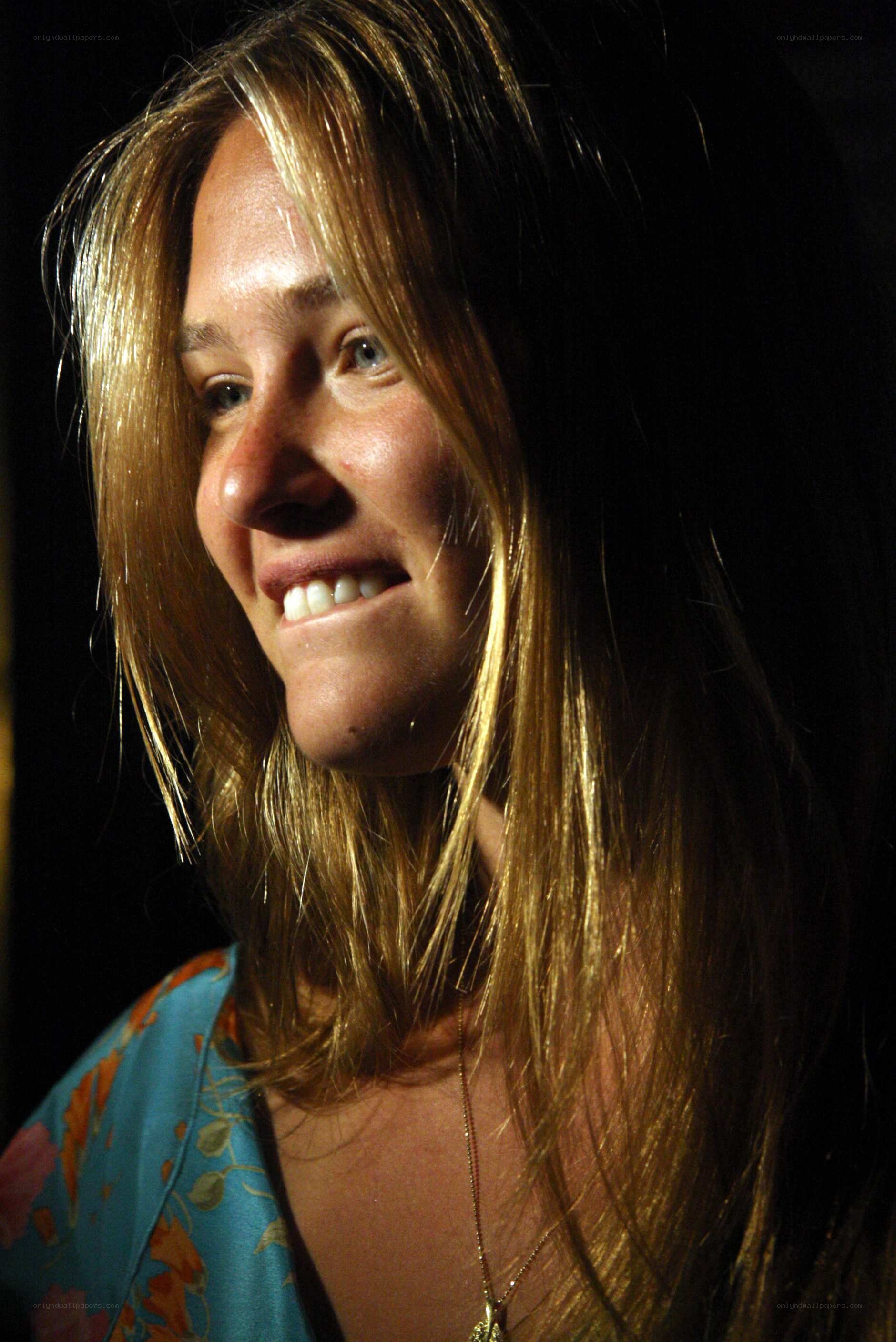woman smiling in dim light
