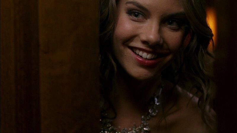 woman smiling in dim light