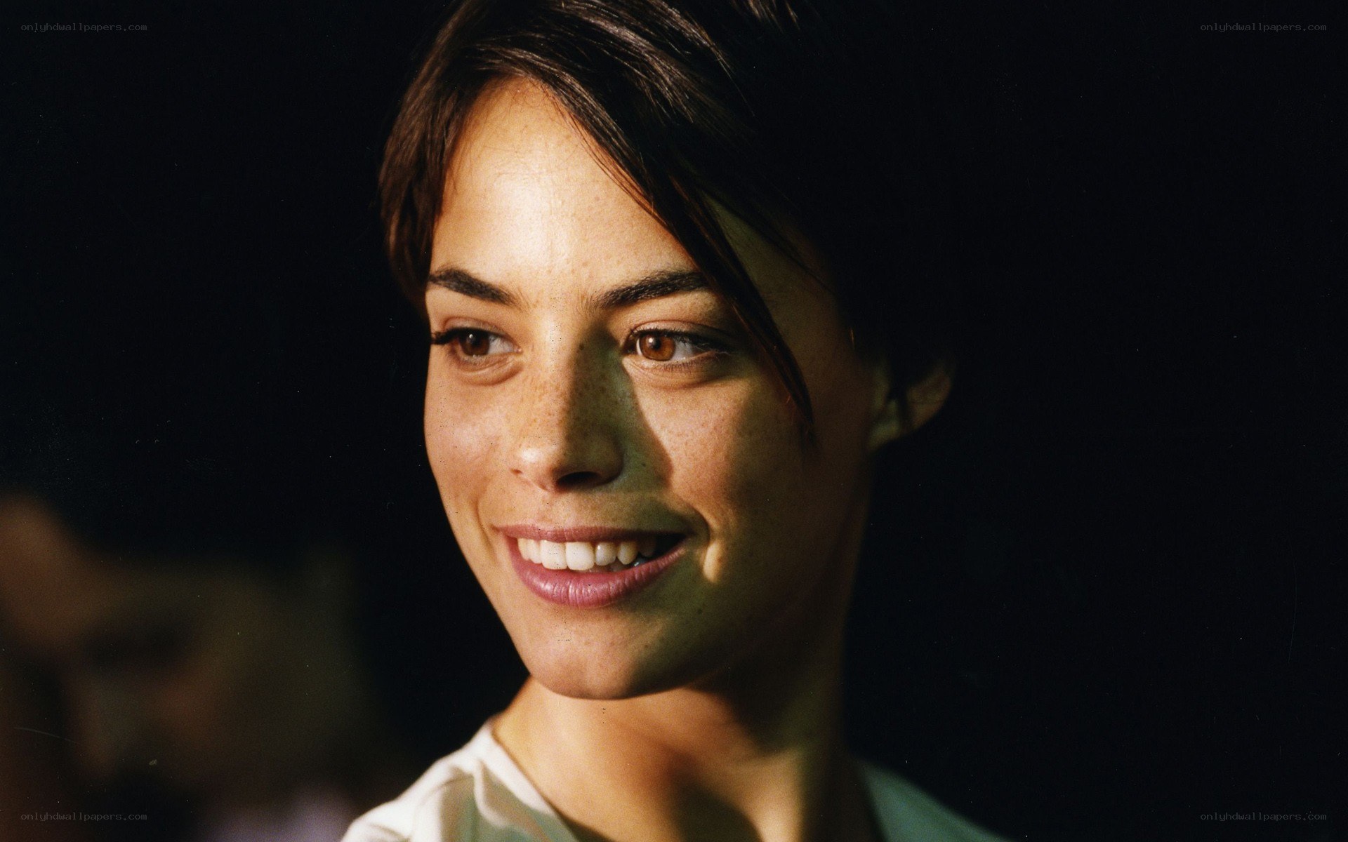woman smiling in dim light