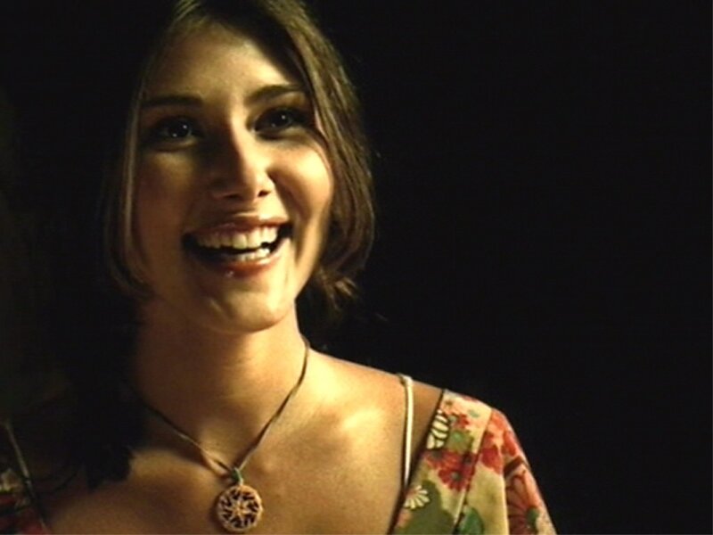 woman smiling in dim light