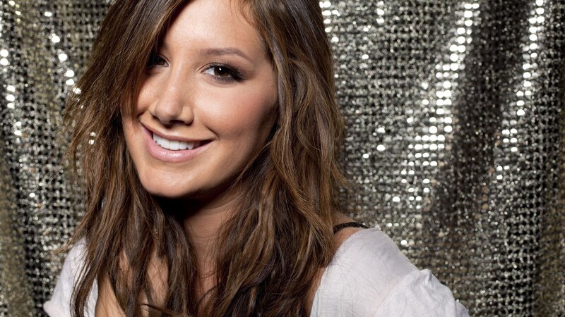 woman smiling in front of sequins