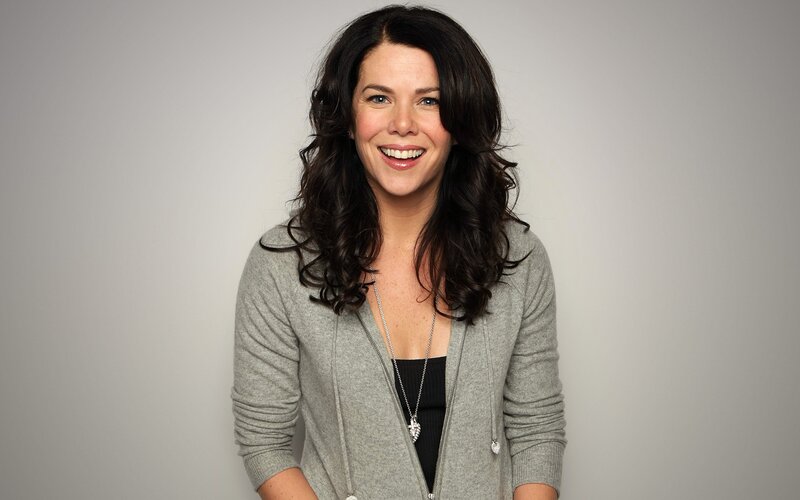 woman smiling in gray cardigan